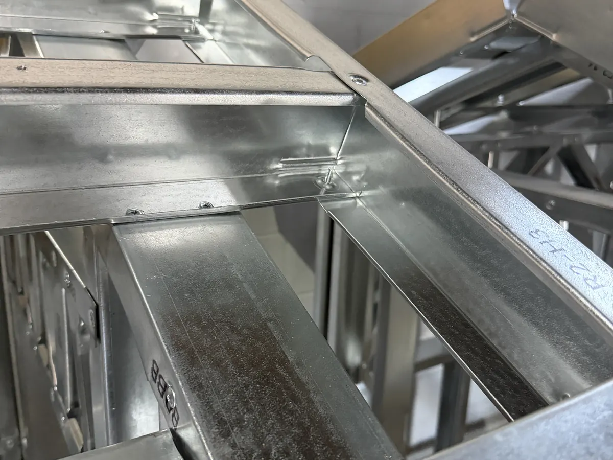 Galvanized steel members screwed together at a joint